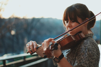 A woman playing the violin near Niagara's Finest Hotels in Niagara-on-the-Lake.