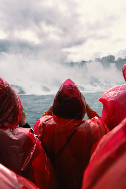 People in rain coats looking at Niagara Falls near Niagara's Finest Hotels in Niagara-on-the-Lake.