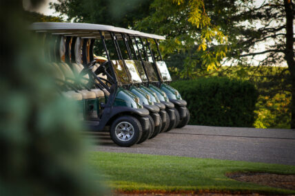 A line of golf carts near Niagara's Finest Hotels in Niagara-on-the-Lake.