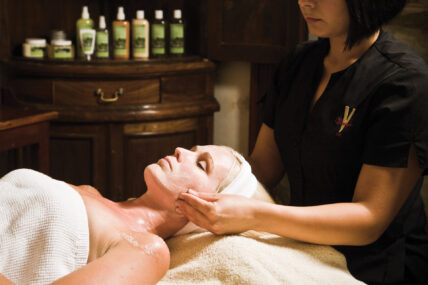 A woman receiving a facial massage near Niagara's Finest Hotels in Niagara-on-the-Lake.