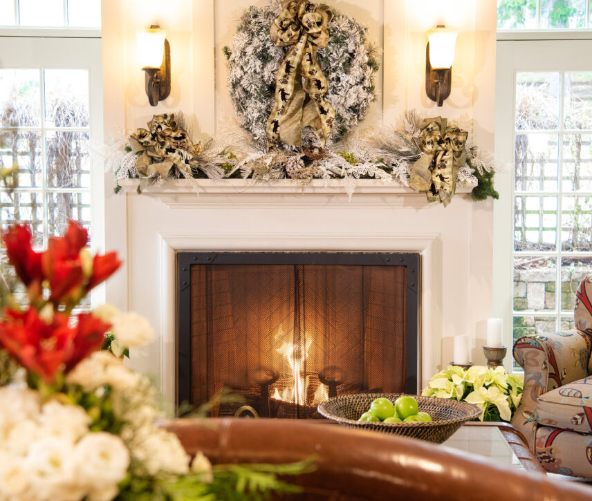 A fireplace with a decorative wreath above it as part of the Holidays at Harbour House package.