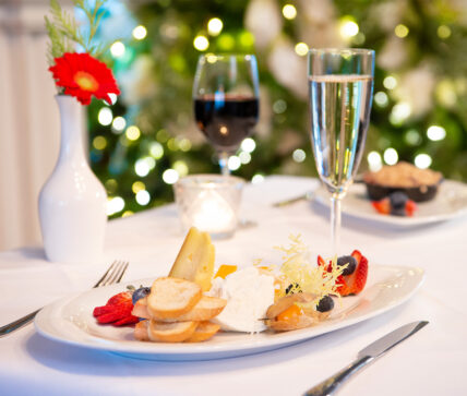 A plate of bread, fruits and cheeses as part of the Holiday Sparkle package.