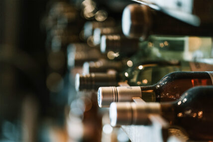 Bottles of wine on a rack as part of the Wine Trolley Signature Trio Package.