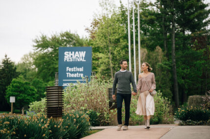 A couple walking past the Shaw Festival Theatre near the Shaw Club Hotel in Niagara-on-the-Lake