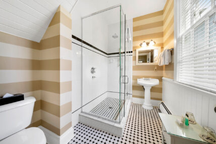 A bathroom with striped wallpaper at The Charles Hotel in Niagara-on-the-Lake.