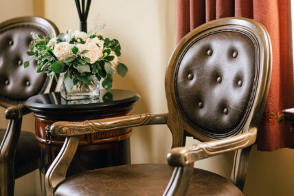 An ornate leather and wood armchair in the Renoir Room at The Charles Hotel in Niagara-on-the-Lake.