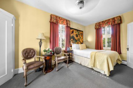 A wide shot of the bedroom in the Renoir Room at The Charles Hotel in Niagara-on-the-Lake.