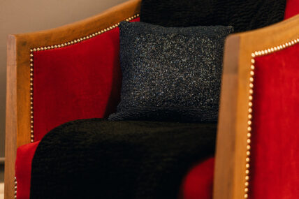 A close up of a decorative pillow on the bed in the Sunflower Room at The Charles Hotel in Niagara-on-the-Lake.
