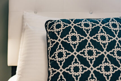 A close up of a decorative pillow on the bed in the Sunflower Room at The Charles Hotel in Niagara-on-the-Lake.