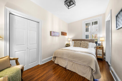 A wide shot of the bedroom in the Apple Room at The Charles Hotel in Niagara-on-the-Lake.