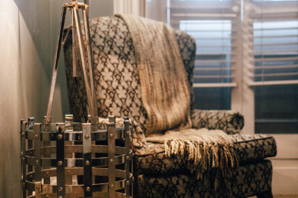 A chair with a blanket on it in the Richardson Room in The Charles Hotel in Niagara-on-the-Lake.