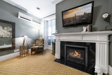 A view of the chair and the fireplace in The Richardson Room at The Charles Hotel in Niagara-on-the-Lake.