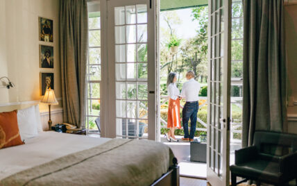 A couple standing on a porch at The Charles Hotel in Niagara-on-the-Lake.