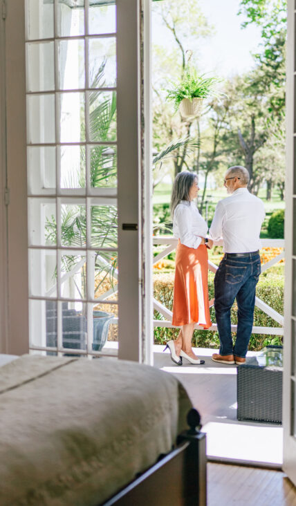 A couple standing on a porch at The Charles Hotel in Niagara-on-the-Lake.