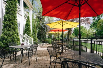 A patio space with shade umbrellas at The Charles Hotel in Niagara-on-the-Lake.