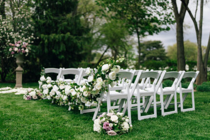 Flowers lain across chairs at an outdoors wedding venue at The Charles Hotel in Niagara-on-the-Lake.