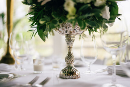 A floral centrepiece in a metal vase.