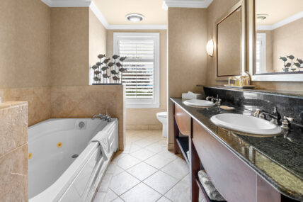 A bathroom with a bathtub in a suite at Harbour House Hotel in Niagara-on-the-Lake.