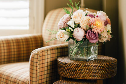 Flowers in a vase beside a chair at Harbour House Hotel in Niagara-on-the-Lake.