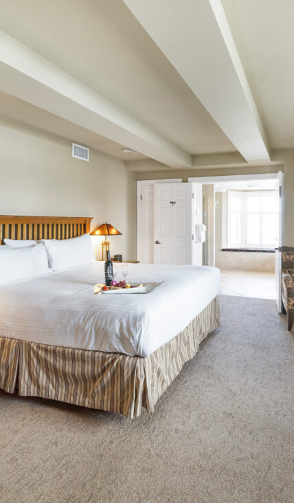Wine and snacks on a bed in the Honeymoon Suite at Harbour House Hotel in Niagara-on-the-Lake.