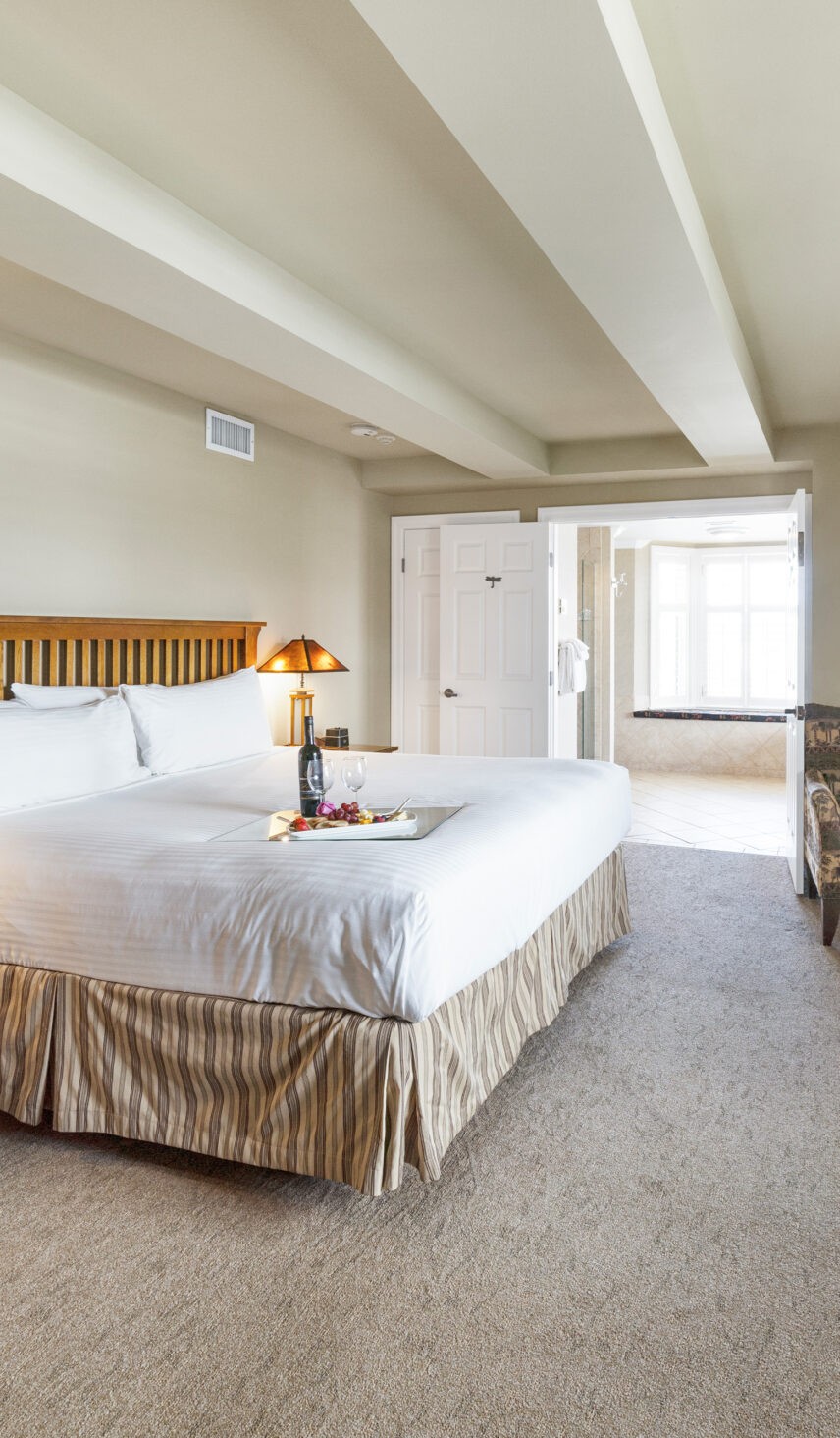 Wine and snacks on a bed in the Honeymoon Suite at Harbour House Hotel in Niagara-on-the-Lake.