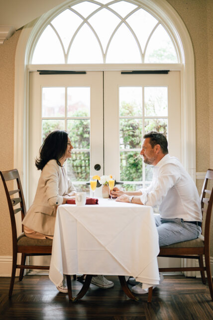 A couple sitting together at a table at Harbour House Hotel in Niagara-on-the-Lake.