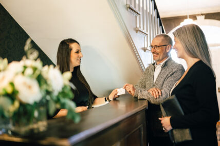 A couple getting their room card at Niagara's Finest Hotels.