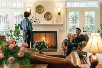 A couple in a room near a fireplace at one of Niagara's Finest Hotels.