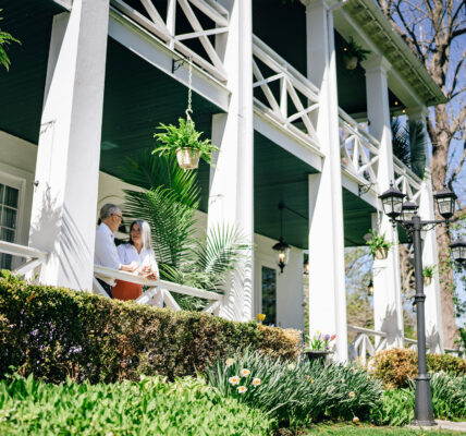 A man and a woman on a porch at Niagara's Finest Hotels in Niagara-on-the-Lake.