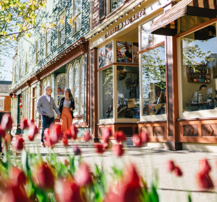 Two people walking down a street in Niagara-on-the-Lake.