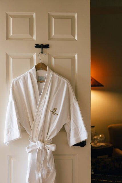 A bathrobe on the back of a door at Niagara's Finest Hotels in Niagara-on-the-Lake.
