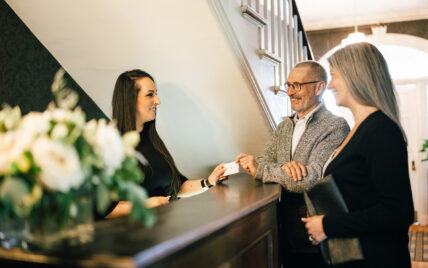 A man getting his room card at Niagara's Finest Hotels in Niagara-on-the-Lake.