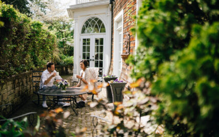 A couple sitting outside at Niagara's Finest Hotels in Niagara-on-the-Lake.