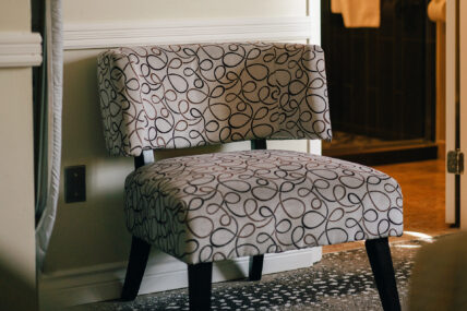 A chair in the Club Room with Whirlpool and Fireplace at the Shaw Club in Niagara-on-the-Lake.