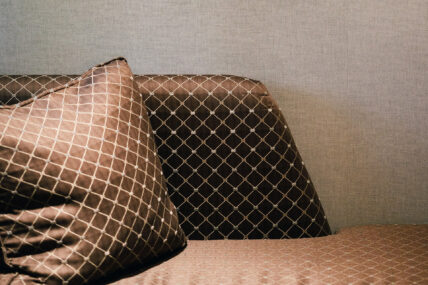 Brown decorative pillows in a deluxe king room at the Shaw Club in Niagara-on-the-Lake.