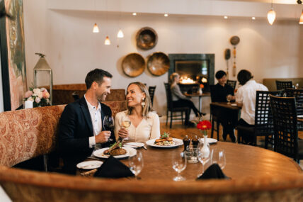 A couple enjoying their meal in the dining room at Zees Grill