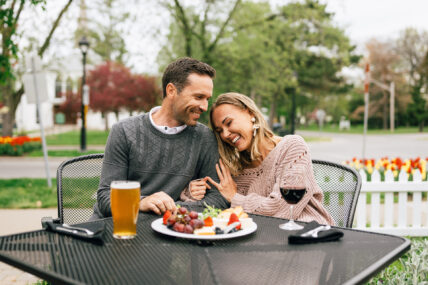 A couple eating food outdoors at the Shaw Club in Niagara-on-the-Lake.