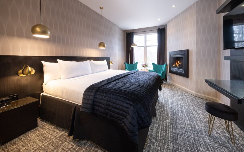 A deluxe king room with a fireplace at the Shaw Club in Niagara-on-the-Lake.