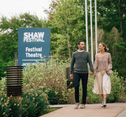A couple walking past the Shaw Festival Theatre near the Shaw Club in Niagara-on-the-Lake.