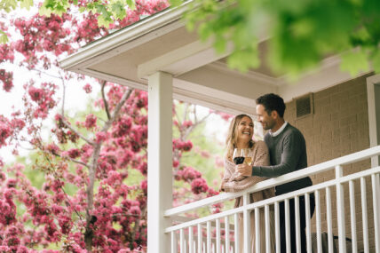 A couple enjoys wine on the balcony at Shaw Club Hotel in Niagara on the Lake during the Spring Fling Getaway