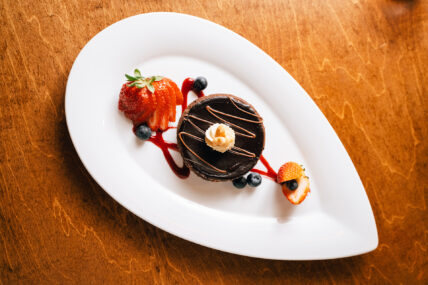 A chocolate cake with fruits on the side at the Shaw Club in Niagara-on-the-Lake.