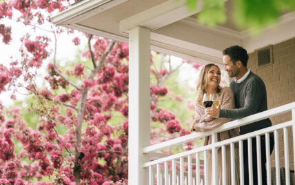 A couple enjoying wine on a balcony at The Shaw Club hotel in Niagara on the Lake