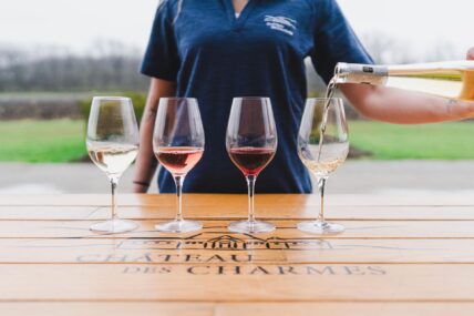 A woman pours a wine tasting flight at Chateau des Charmes in Niagara-on-the-Lake