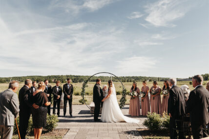 A wedding ceremony being held at Queenston Mile Vineyard, a Niagara on the Lake wedding venue