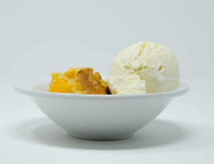 Homemade peach cobbler with vanilla ice cream in Niagara-on-the-Lake.